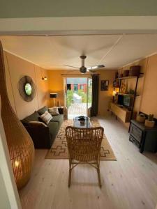 a living room with a couch and a table at Cottage de la Risle in Pont-Audemer