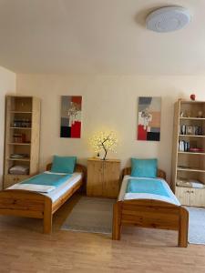 two beds in a room with wooden shelves at Tápé in Szeged