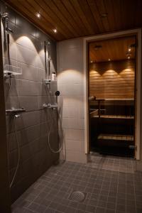 uma casa de banho com um chuveiro e uma porta de vidro em Unique City Home in Rovaniemi em Rovaniemi