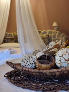 a basket filled with different items on a bed at Maria's Paradise in Vonitsa