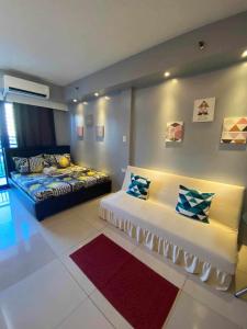 a living room with a bed and a couch at Sea Residences in Manila