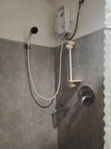 a shower with a shower head in a bathroom at Sea Residences in Manila