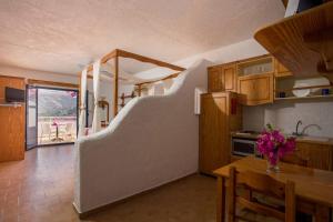 a kitchen with a staircase leading up to a room at ILIDI Rock in Livadia +43 photos