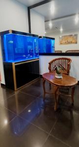 a living room with a table and a large tv at MILAN HOTEL in Johor Bahru