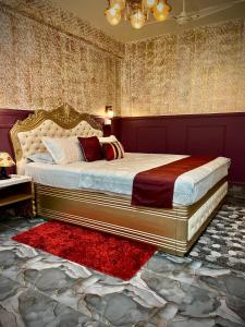 a bedroom with a king sized bed with a red rug at The Atlantis Guwahati in Guwahati