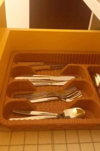 a tray filled with utensils and a spoon at Mila's Home in Burgas