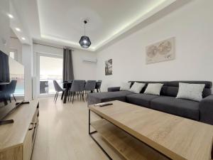 a living room with a couch and a table at Aristotelous Spacious 109sqm apt in Athens in Athens