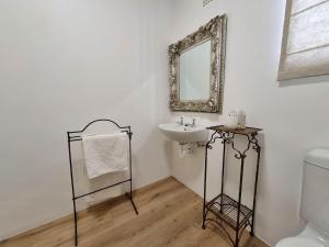 a bathroom with a sink and a mirror on the wall at Palmview House in Hermanus