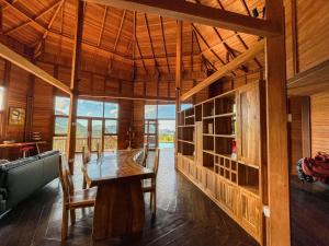 a dining room with a wooden table and chairs at Villa Russerangan Grand Opening in Praya