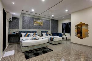 a hotel room with two beds and a couch at DIAMOND HOTEL in Mumbai