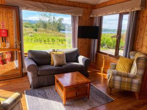 a living room with a couch and a table at Dulrush Self-Catering Lodges in Belleek