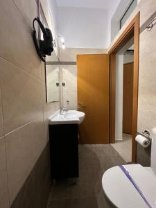 a bathroom with a sink and a mirror at Elegant Escapes 5 in Athens
