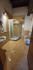 a bathroom with two sinks and a shower and two toilets at Hotel Tenuta dell'Argento Resort in Civitavecchia