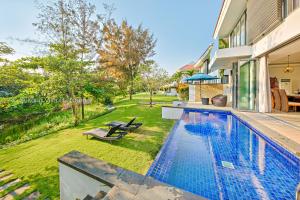 a swimming pool in the backyard of a house at Tran Beach Front Luxury Villa in Da Nang