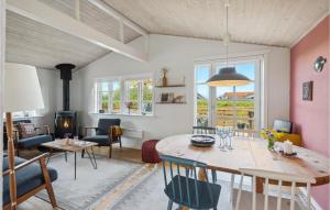 a living room with a table and chairs and a fireplace at Lovely Home In Mesinge With Wifi in Mesinge