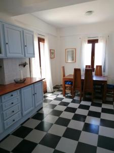 a kitchen with a black and white checkered floor at Litani House in Raches