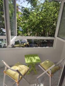 two chairs and a table in front of a window at Desafinado in Burgas City