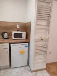 a kitchen with a microwave on top of a refrigerator at Desafinado in Burgas City