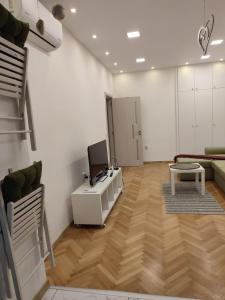 a living room with a couch and a desk with a television at Desafinado in Burgas City