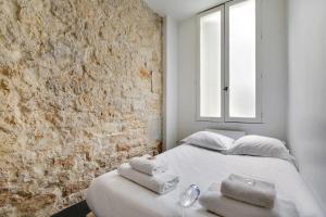 a bedroom with a bed with towels on it at CMG Louis Blanc - Gare de l'Est in Paris