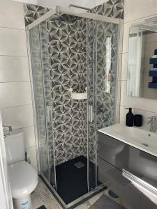 Un baño con ducha, inodoro y lavabo. en Los Alamos de Cotillo, en Cotillo