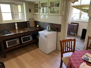 a kitchen with a white refrigerator and a microwave at Eling Forest Winery in Sutton Forest
