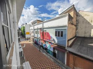 a train with graffiti on the side of a building at Melawati Ria Hotel in Kuala Selangor