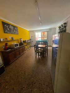 a kitchen and dining room with a table and chairs at Hostal Milmarcos in Zaragoza +45 photos