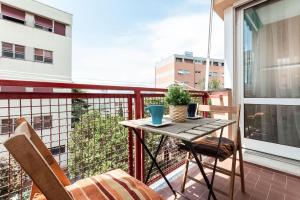 einen Balkon mit einem Holztisch und Stühlen in der Unterkunft Oasi di pace a 10 min. dall'aeroporto in Genua