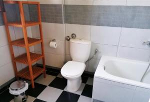 a bathroom with a toilet and a bath tub at Litani House in Raches