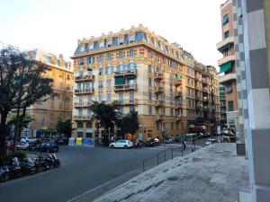 a large building with cars parked in front of a street at il Rifugio del Marinaio in Genova