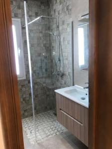 a bathroom with a shower and a sink at Villa Houmet Souk in Houmt Souk