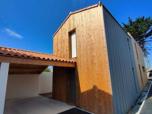 a wooden building with a window on top of it at Escapade aux dunes in Brétignolles-sur-Mer