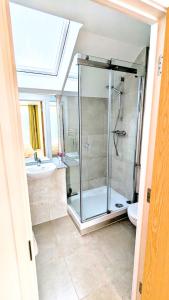 a bathroom with a shower and a toilet and a sink at 3 Bedroom house in Camberwell in London