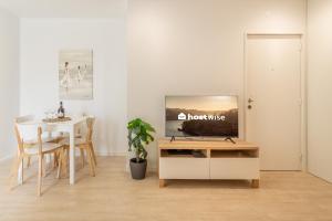 a living room with a television on a tv stand at Host Wise - Peaceful Sunny Flat - Ace Location in Porto