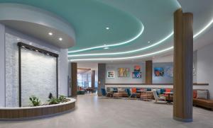 a lobby of a hospital with a blue ceiling at Tru By Hilton Pompano Beach Pier in Pompano Beach