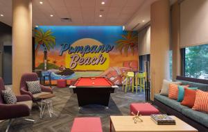 a lobby with a pool table and a ping pong board at Tru By Hilton Pompano Beach Pier in Pompano Beach