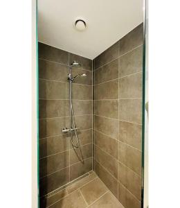 a shower stall with a shower head in a bathroom at ApartmentInCopenhagen Apartment 1561 in Copenhagen