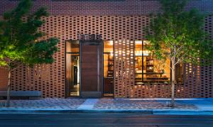 a building with a glass door on a brick wall at Tommie Austin, JDV by Hyatt in Austin
