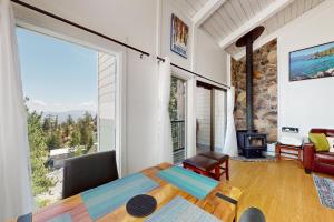 a room with a bed and a large window at Sunrise Serenity at Tahoe Village in Stateline