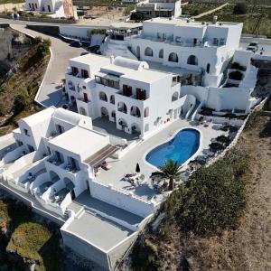 an aerial view of a large white building with a swimming pool at Santorini View in Akrotiri