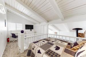 a white bedroom with a bed and a desk at Sunrise Serenity at Tahoe Village in Stateline