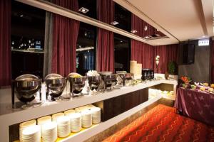 a restaurant with plates and wine glasses on a counter at Ramada Encore By Wyndham Hualien in Hualien City