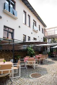 a patio with tables and chairs in front of a building at ART Hotel in Sibiu