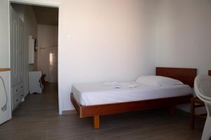 a small bedroom with a bed in a room at Sea Breeze 2 Apartments in Mastichari