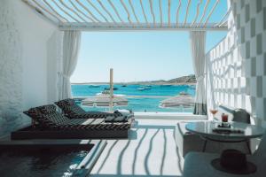 a living room with a view of the ocean at Mykonos Blanc - Preferred Hotels & Resorts in Ornos