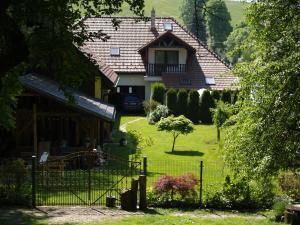 a house with a gate in front of a yard at Privat 66 in Liptovský Trnovec