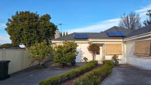 a house with solar panels on top of it at A cozy place in Noble Park