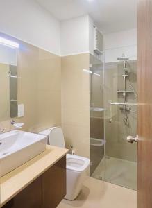 a bathroom with a toilet and a sink and a shower at Ocean breeze Hotel Studio Negombo by Shane in Negombo