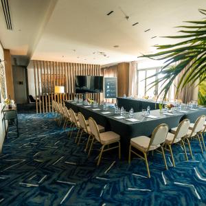 a long table and chairs in a room at Jareed Hotel Riyadh in Riyadh